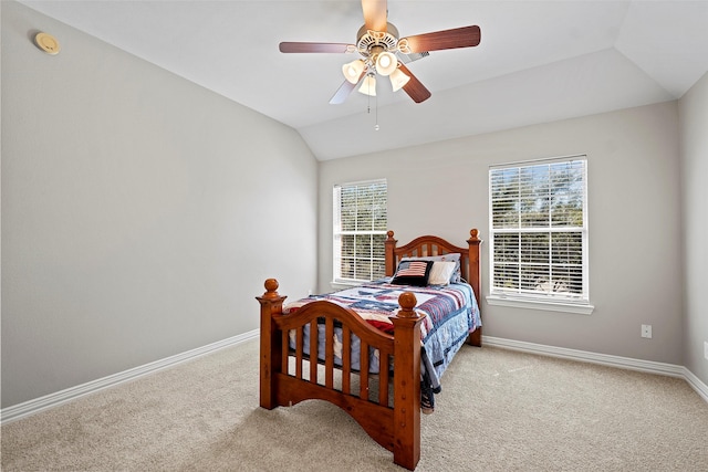 bedroom with lofted ceiling, carpet flooring, and baseboards