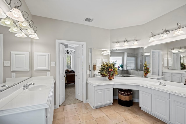 bathroom featuring visible vents, two vanities, a sink, and tile patterned floors