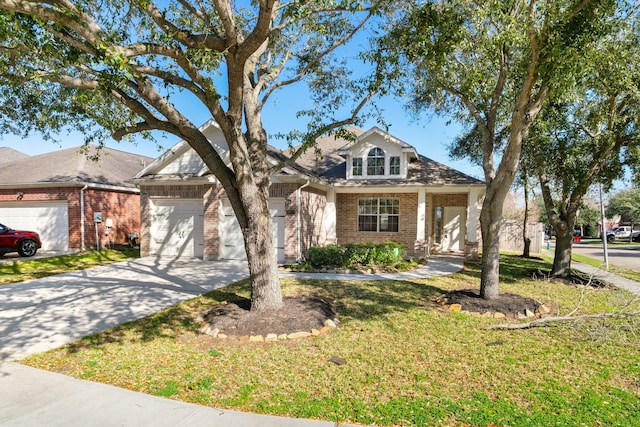 view of front of home featuring a front yard, an attached garage, brick siding, and driveway