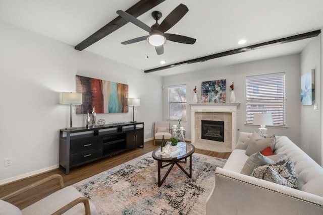 living room with beam ceiling, plenty of natural light, wood finished floors, and baseboards