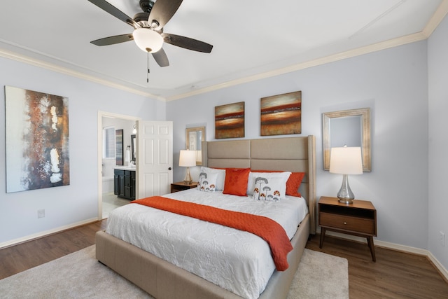 bedroom featuring crown molding, baseboards, and wood finished floors