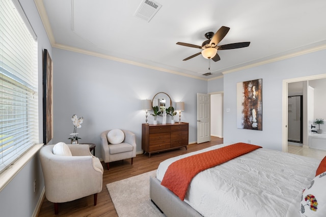 bedroom with crown molding, wood finished floors, visible vents, and ceiling fan