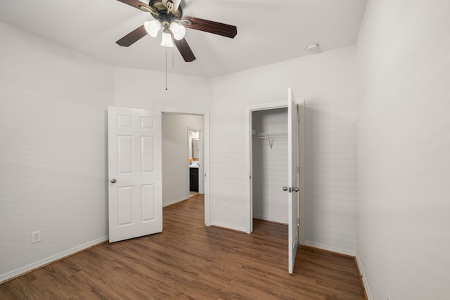 unfurnished bedroom featuring a ceiling fan, wood finished floors, a closet, and baseboards