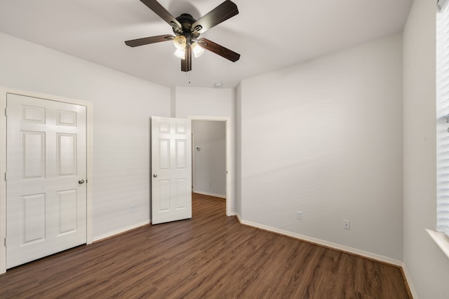 unfurnished bedroom with dark wood-style floors, baseboards, and ceiling fan