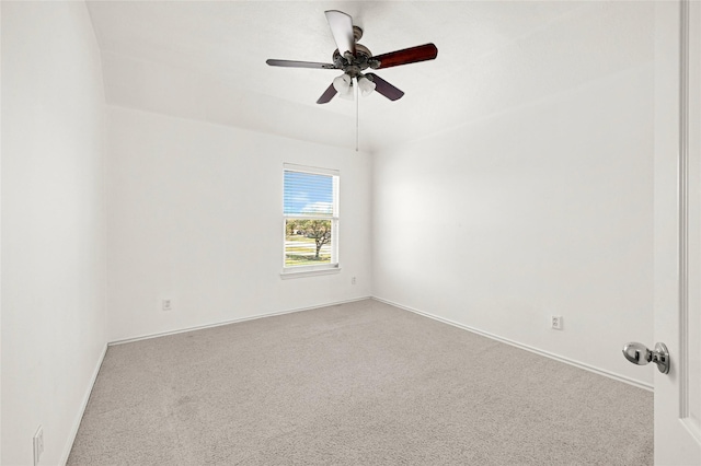 carpeted empty room featuring ceiling fan and baseboards