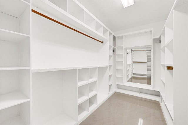 spacious closet with tile patterned floors