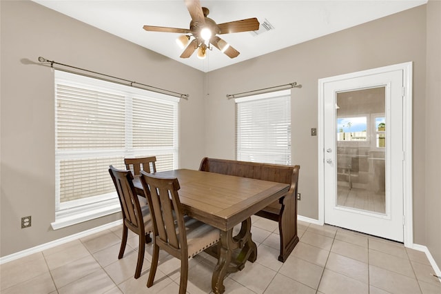 dining area featuring light tile patterned floors, baseboards, visible vents, and ceiling fan