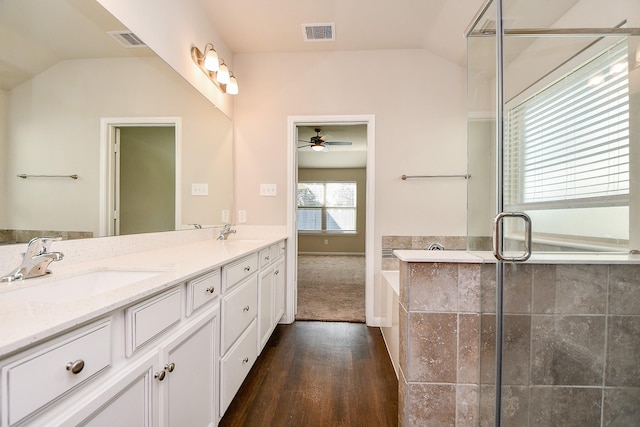 bathroom featuring vaulted ceiling, visible vents, and a sink