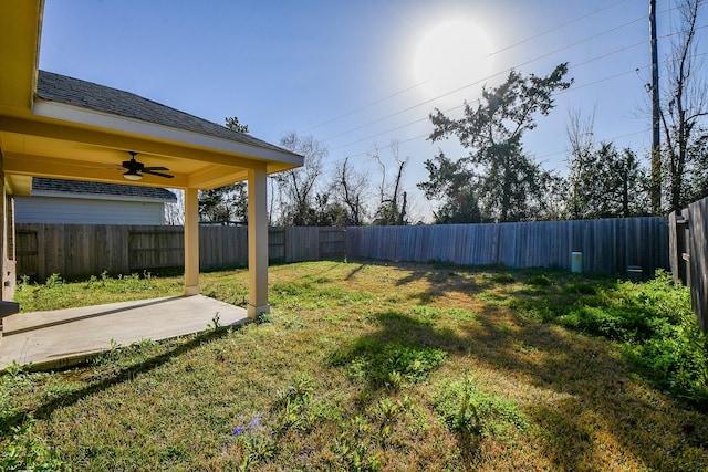 view of yard with a patio area, ceiling fan, and a fenced backyard