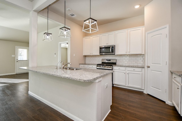 kitchen featuring dark wood finished floors, appliances with stainless steel finishes, a sink, and visible vents