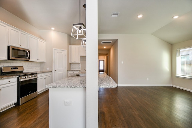 kitchen featuring lofted ceiling, visible vents, appliances with stainless steel finishes, and tasteful backsplash