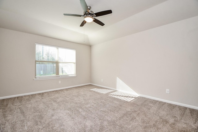 unfurnished room featuring carpet floors, baseboards, a ceiling fan, and lofted ceiling