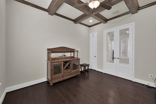 spare room featuring visible vents, coffered ceiling, baseboards, dark wood finished floors, and french doors