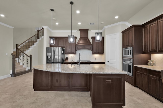 kitchen with premium range hood, stainless steel appliances, dark brown cabinetry, and visible vents