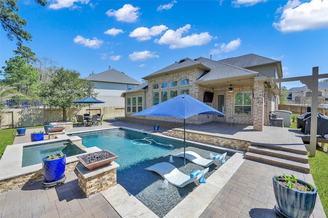 view of pool with outdoor dining space, a patio, a fenced in pool, a fenced backyard, and a fire pit