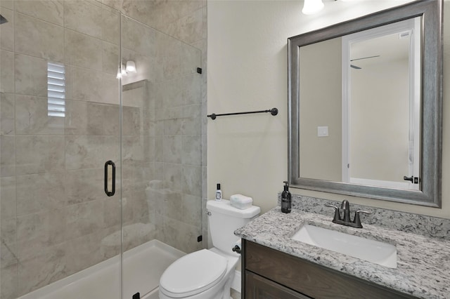 full bath with toilet, a stall shower, and vanity