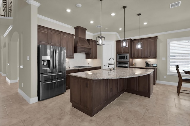 kitchen with visible vents, custom exhaust hood, a sink, stainless steel appliances, and dark brown cabinetry