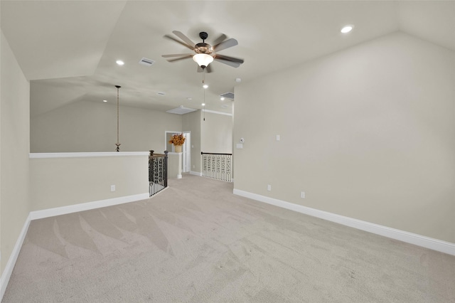 interior space with visible vents, recessed lighting, baseboards, lofted ceiling, and light colored carpet