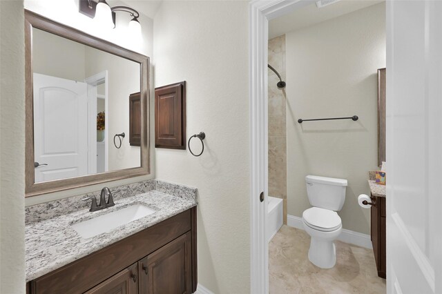 bathroom featuring tile patterned flooring, baseboards, toilet, shower / bathing tub combination, and vanity