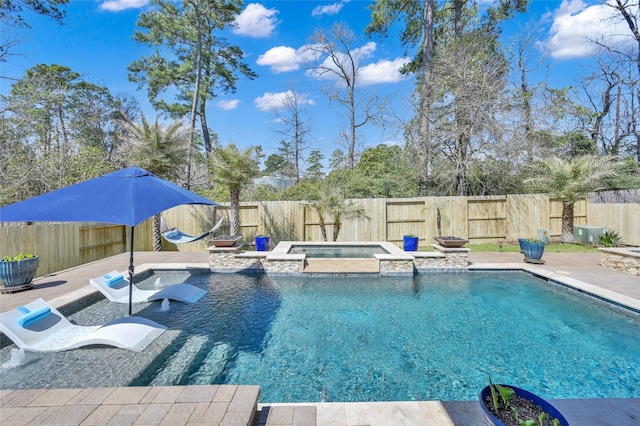 view of pool featuring a patio area, a fenced backyard, and a pool with connected hot tub