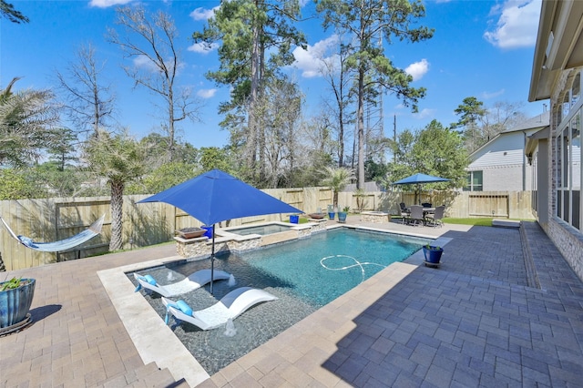 view of pool with outdoor dining area, a patio, a fenced backyard, a fenced in pool, and an in ground hot tub