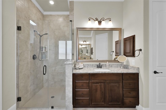 full bath with a stall shower, vanity, and crown molding