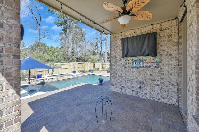 view of pool featuring a fenced in pool, a fenced backyard, a patio area, an in ground hot tub, and a ceiling fan