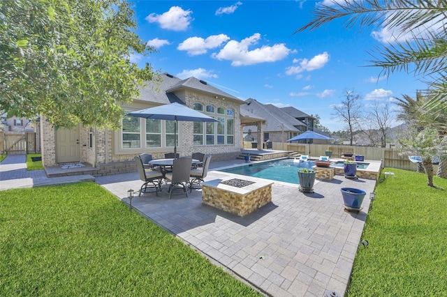 view of pool featuring a patio area, a yard, a fire pit, and a fenced backyard