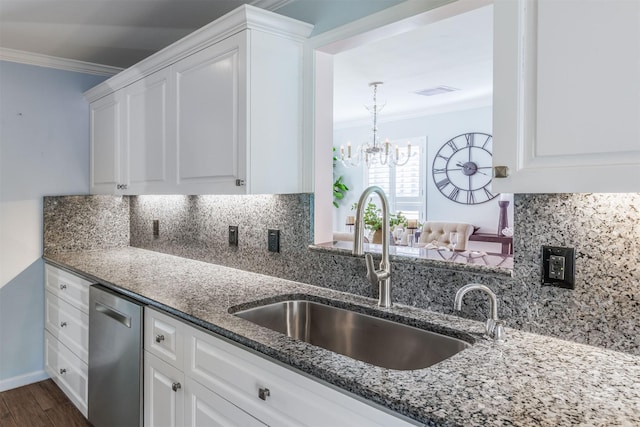 kitchen featuring a sink, decorative backsplash, dishwasher, dark stone countertops, and crown molding