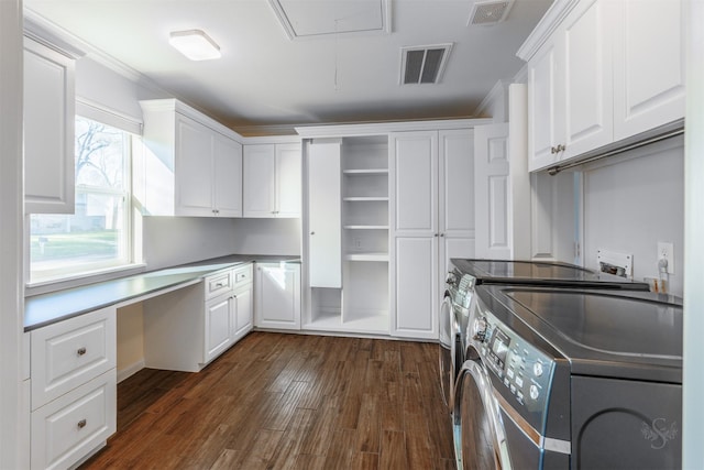 laundry area with cabinet space, attic access, visible vents, and washer and dryer