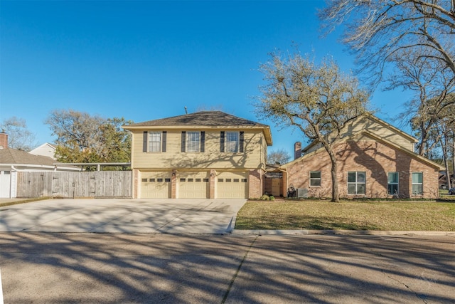 view of front of property with driveway, brick siding, an attached garage, fence, and a front yard