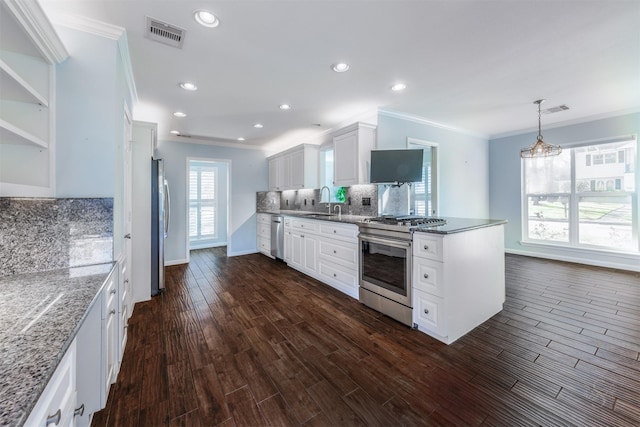 kitchen with dark wood-style flooring, visible vents, backsplash, appliances with stainless steel finishes, and white cabinets