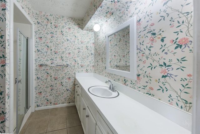 full bath featuring wallpapered walls, tile patterned flooring, baseboards, and vanity