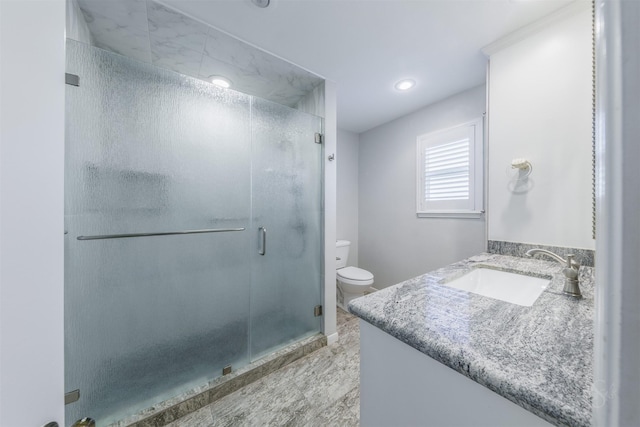 bathroom with a stall shower, vanity, toilet, and recessed lighting