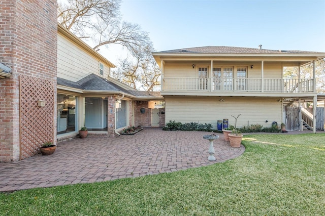 rear view of property with a patio area and a lawn