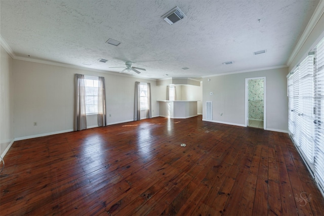 empty room featuring visible vents, ornamental molding, and hardwood / wood-style flooring