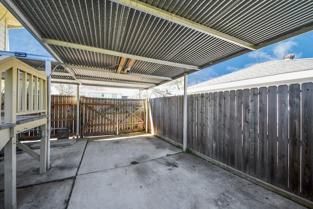 view of patio featuring a gate and fence