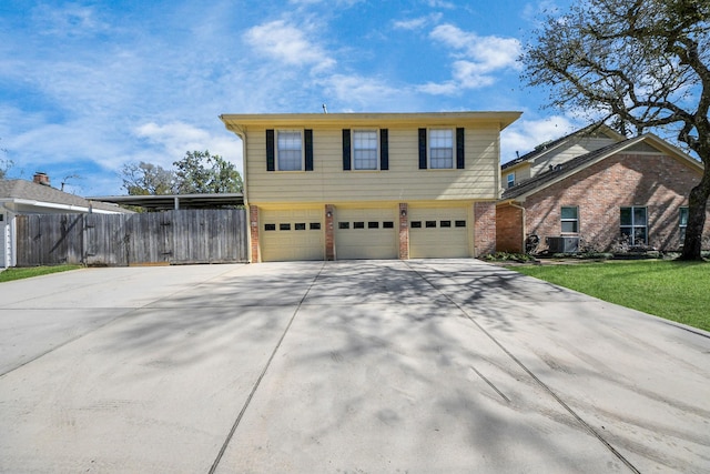 view of front of property with an attached garage, brick siding, fence, driveway, and a front yard