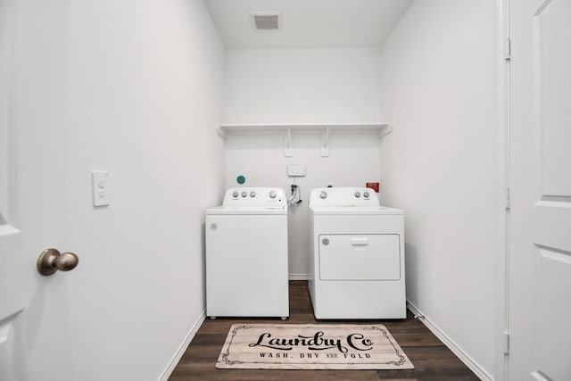 laundry room featuring laundry area, visible vents, separate washer and dryer, and dark wood-type flooring