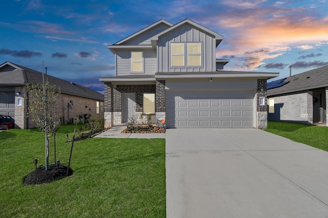 view of front facade with driveway, an attached garage, a lawn, and board and batten siding