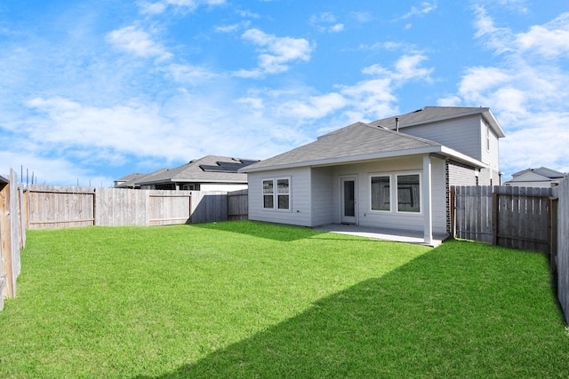 rear view of property with a patio area, a fenced backyard, and a lawn