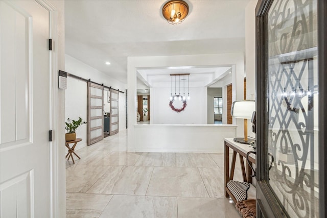 entrance foyer with a barn door and baseboards