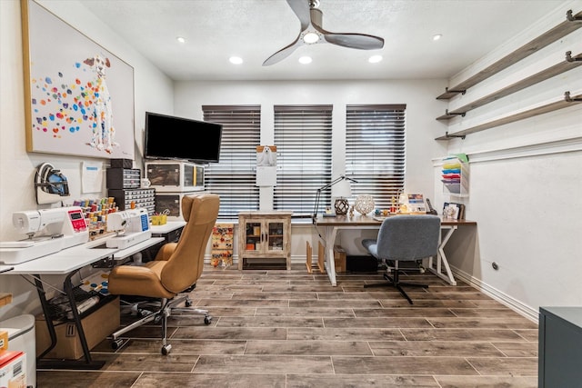 home office with ceiling fan, wood tiled floor, and baseboards