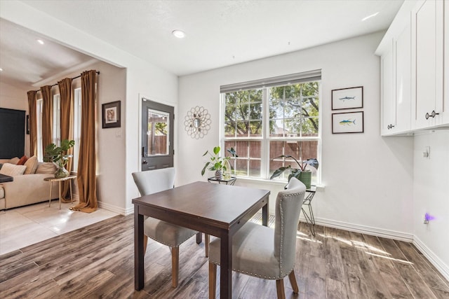 dining area with recessed lighting, baseboards, and wood finished floors