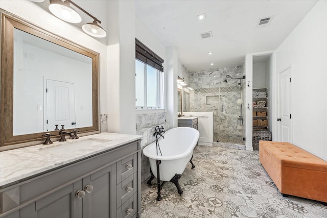 bathroom featuring a stall shower, visible vents, a freestanding tub, and vanity