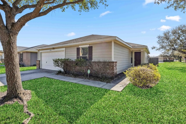 view of front facade with a garage, concrete driveway, and a front yard