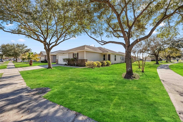 view of side of home with a garage, driveway, and a yard