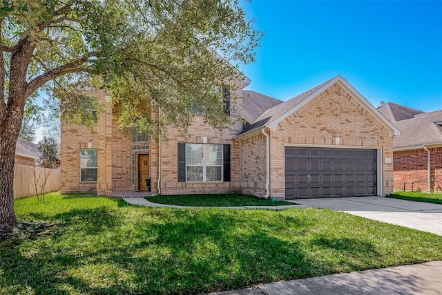 traditional-style house with an attached garage, brick siding, fence, driveway, and a front lawn