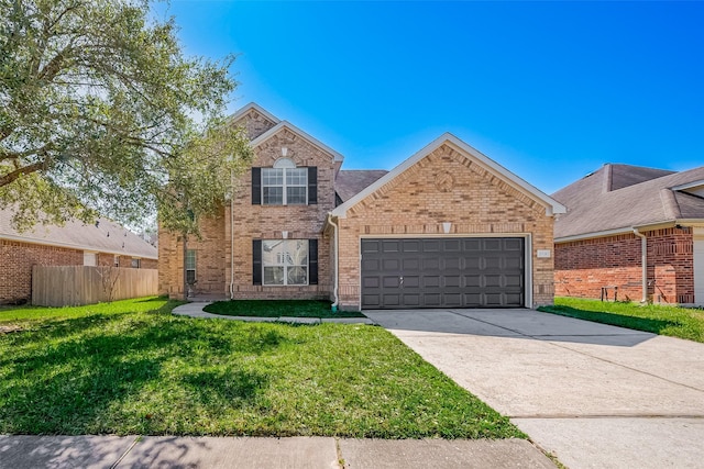 traditional home featuring brick siding, an attached garage, a front yard, fence, and driveway