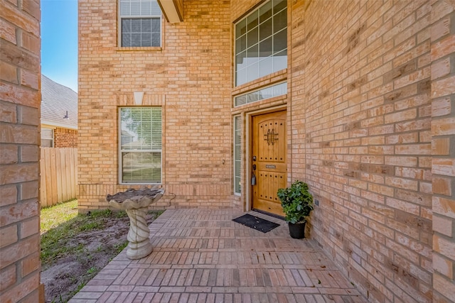 property entrance featuring brick siding